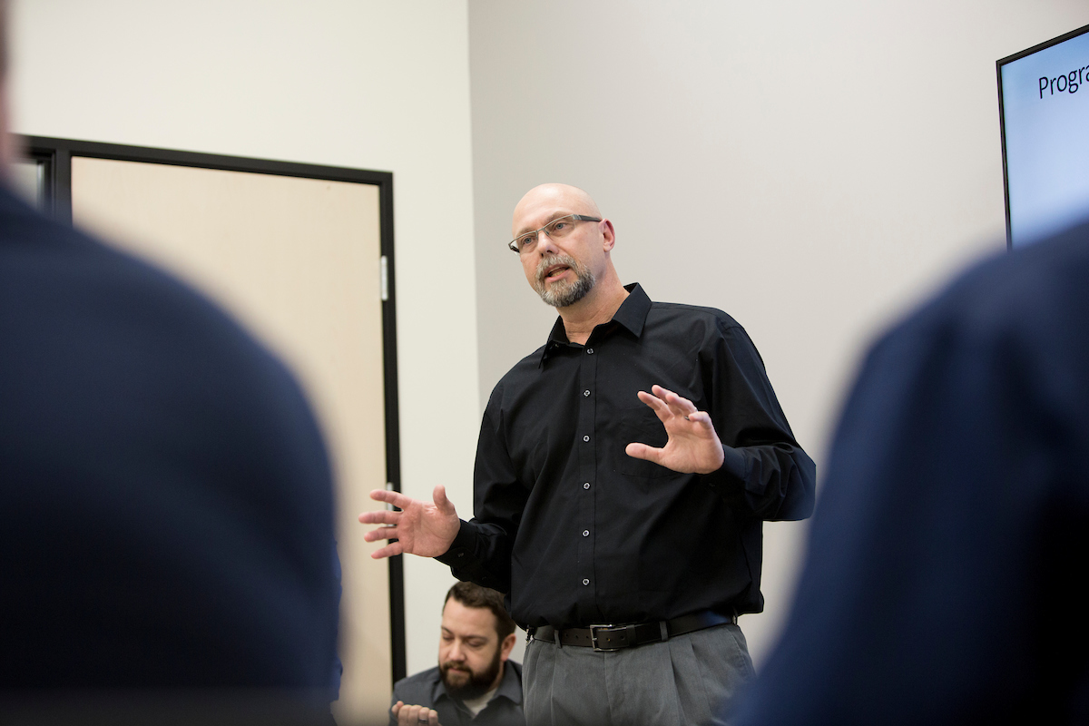 Man instructing a class.
